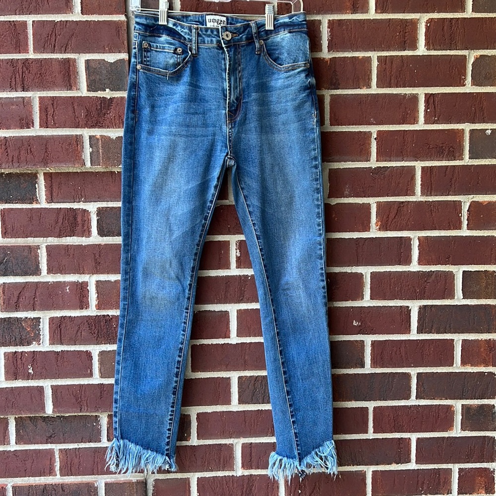 Unfeeling denim high waisted jeans with distressed hem.